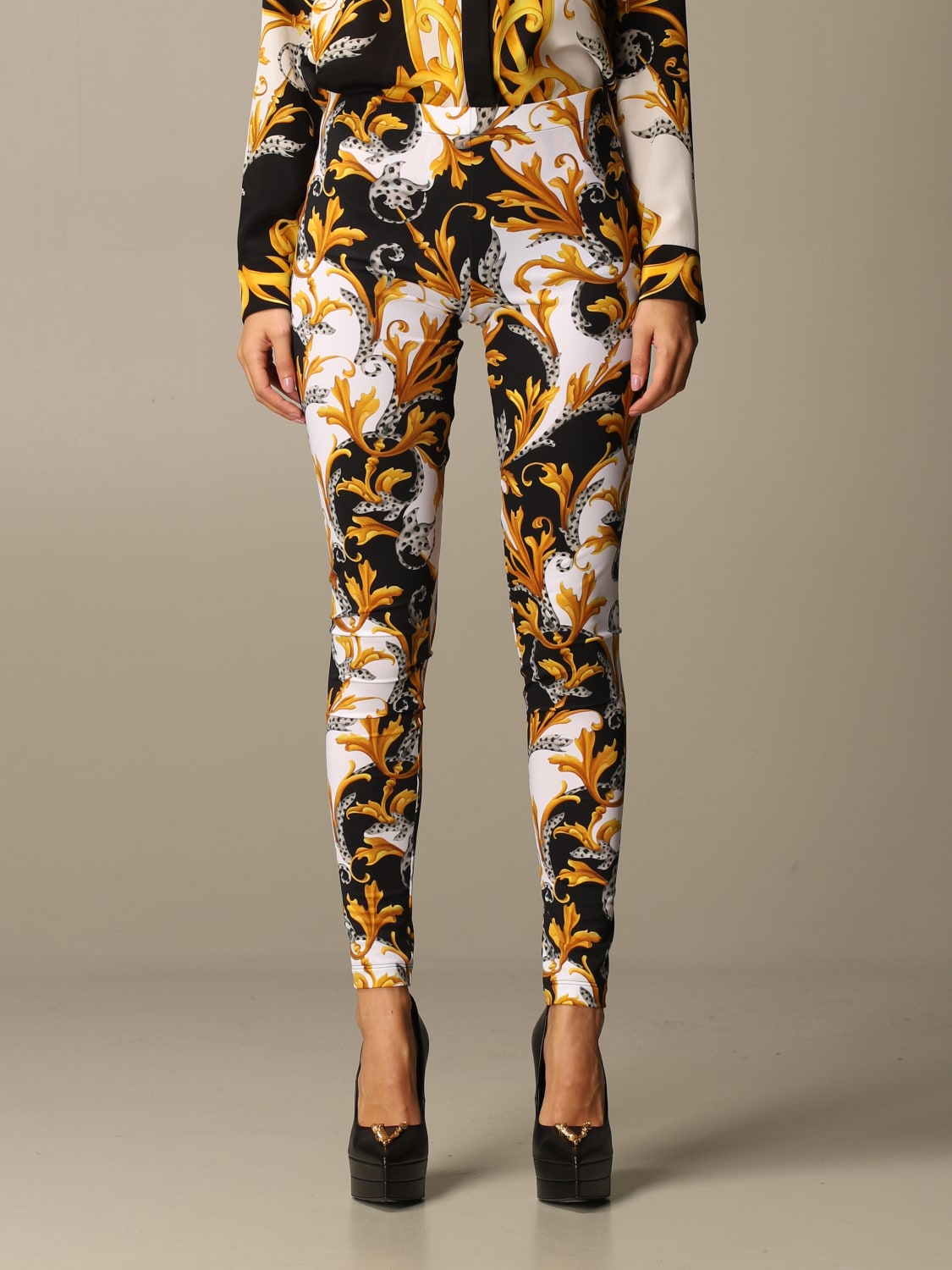 VERSACE: leggings with baroque pattern - Gold