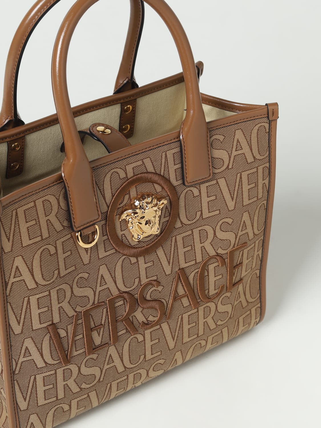 Read chorus experience VERSACE: Allover bag in jacquard fabric - Beige | Versace handbag  10058611A08199 online at GIGLIO.COM